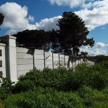 2. Squatter buildings attached to cemetery fence